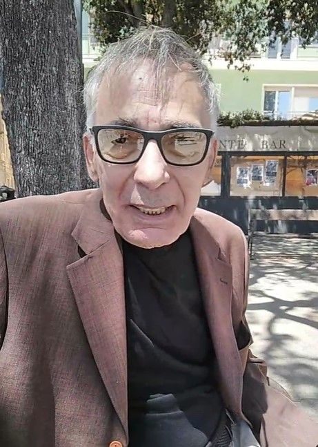 Un’immagine di Gigi Monello, ritratto nella piazza antistante il Tribunale di Cagliari in occasione della sesta udienza del processo a suo carico (fonte: Associazione Diritti alla Follia).